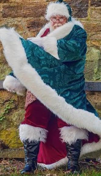 CJ Kringle swirling his Santa coat