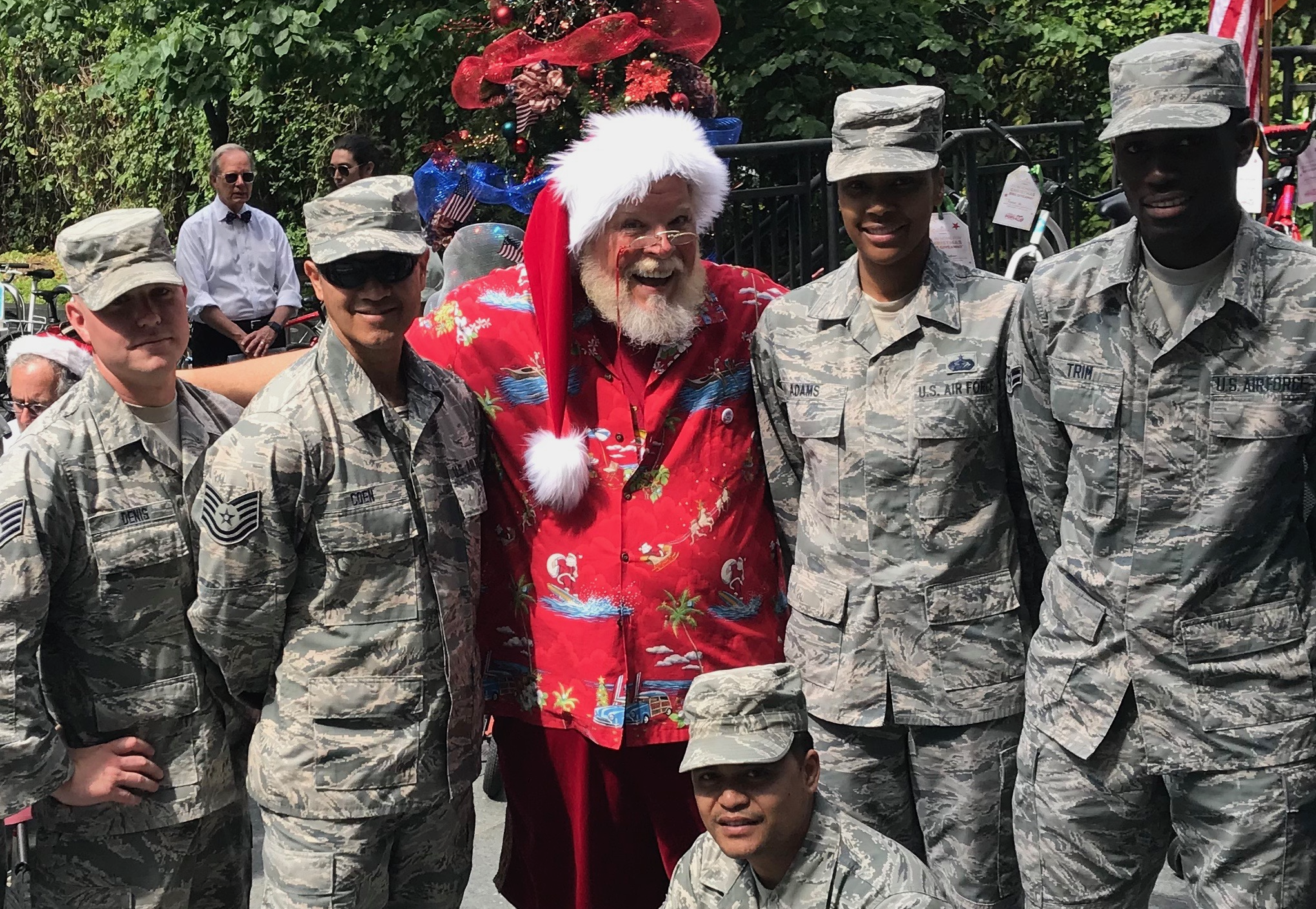 CJ Kringle saluting alongside uniformed soldiers
